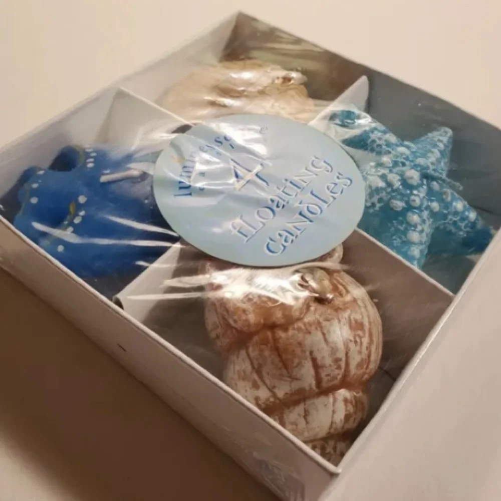 New sealed luminescence 4 floating candles. Fish, shells, and Star fish